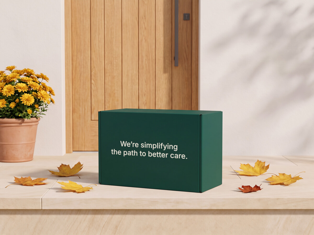 A green box on a front step with fall leaves and flowers, printed with the words "We're simplifying the path to better care"